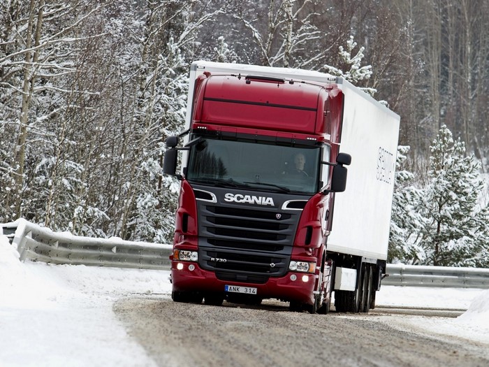 Red Scania R730 Truck driving on a snowy road