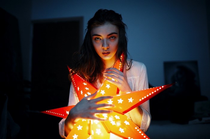 Woman holding a glowing star lantern