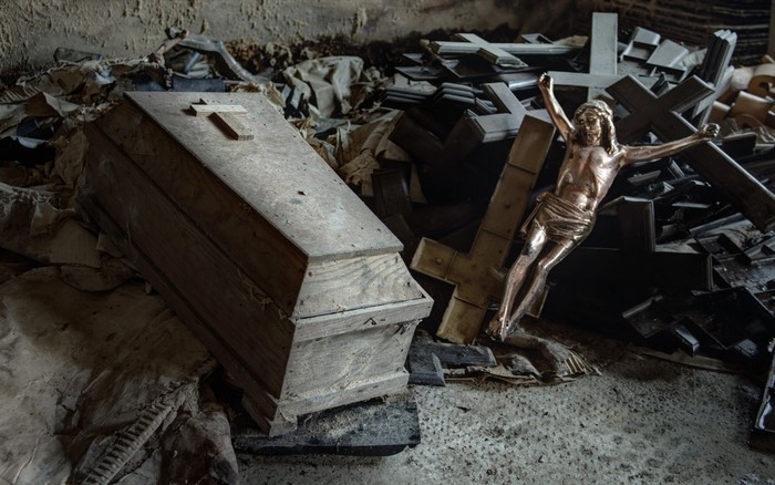 Coffin and crosses in a derelict building