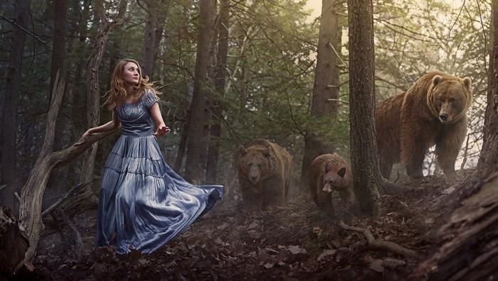 Woman in blue dress encounters bears in a forest