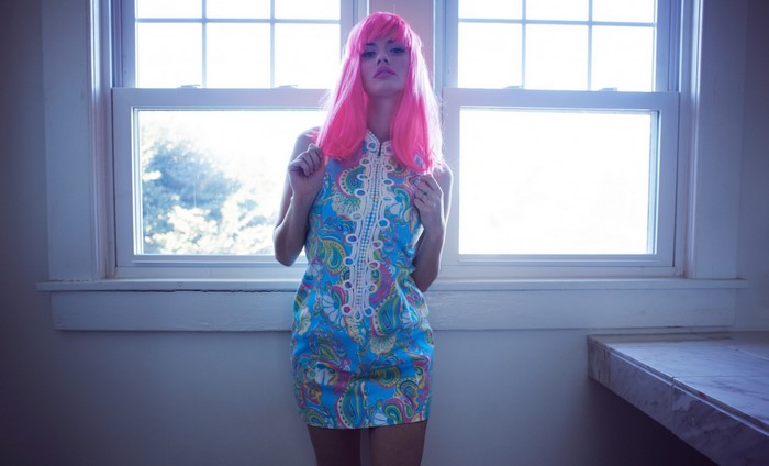 Woman with pink hair wearing a blue dress