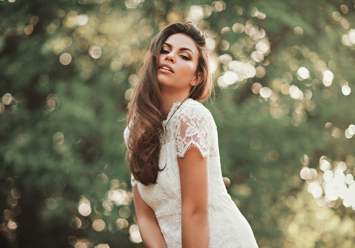 Woman in white lace dress outdoors