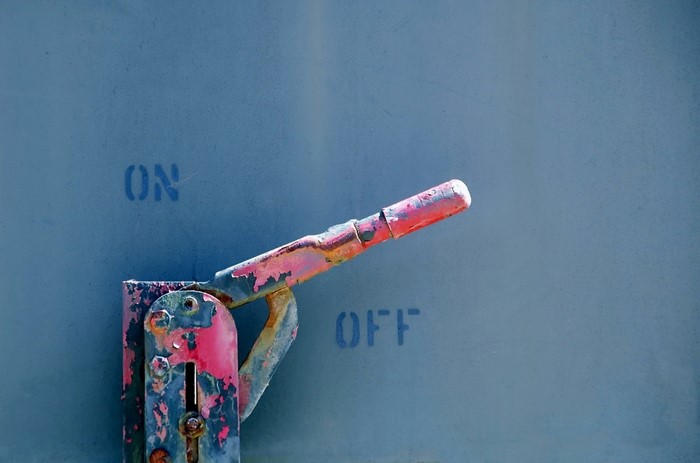 Rusty red and blue lever with ON and OFF labels