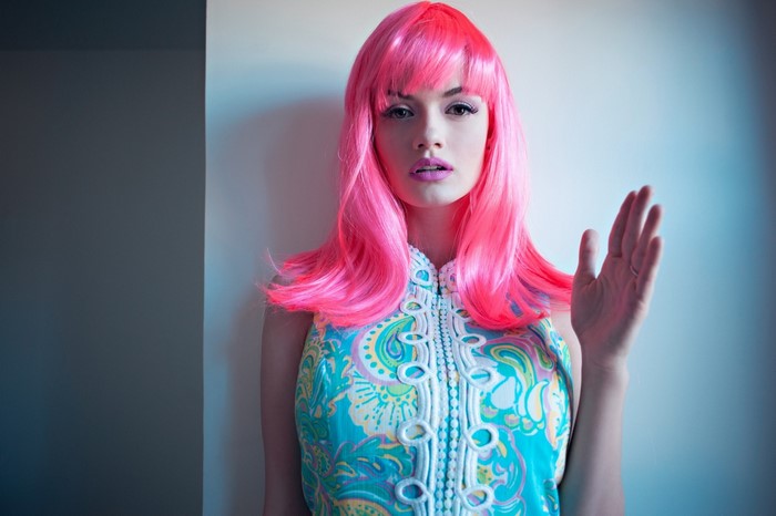 Woman with pink wig and colorful dress