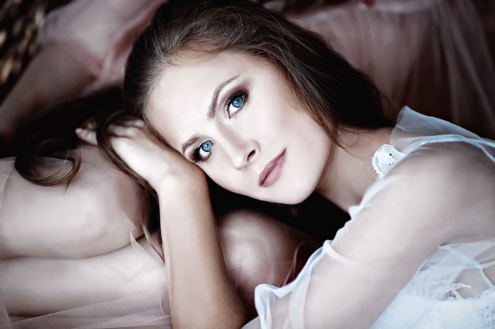Woman with blue eyes wearing sheer clothing