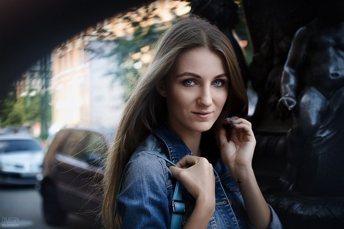 Woman in denim jacket with blue bag