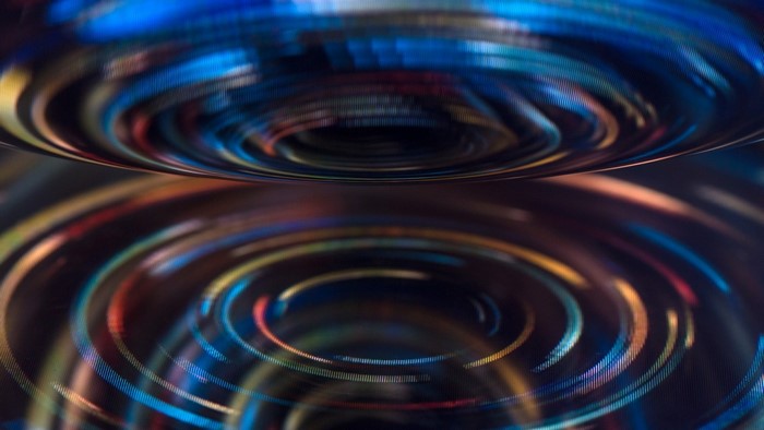 Abstract digital art with swirling colorful lights and reflections