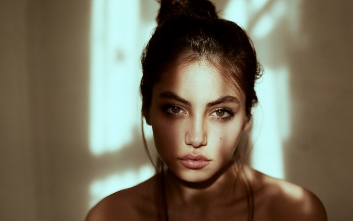 Woman with dark hair in a bun, portrait photography