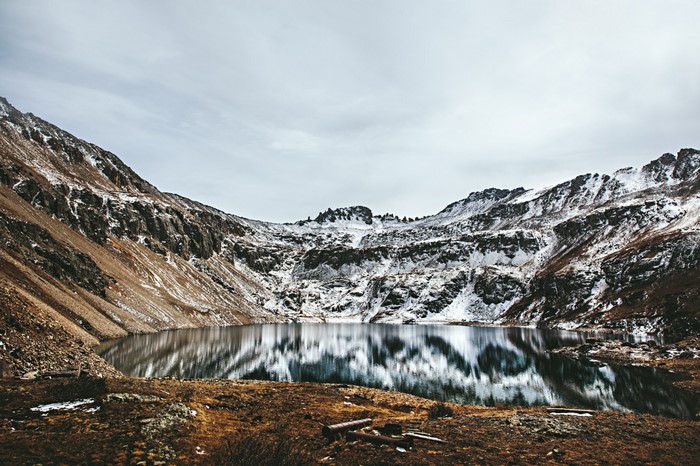 Snow-capped mountains reflected in a calm lake