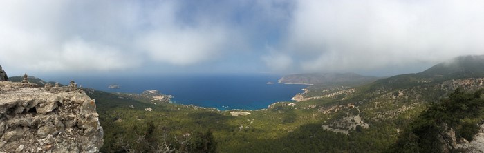 Panoramic view of a rugged coastline with mountains and sea