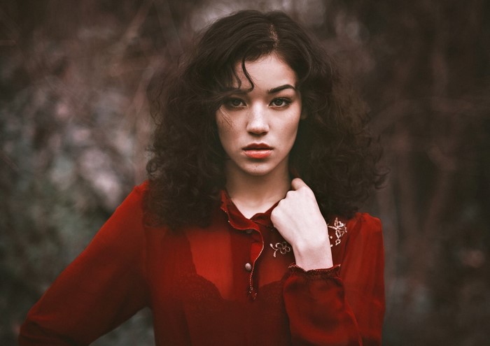 Woman with curly hair in a red top