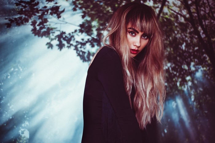 Woman with dyed hair in a forest setting