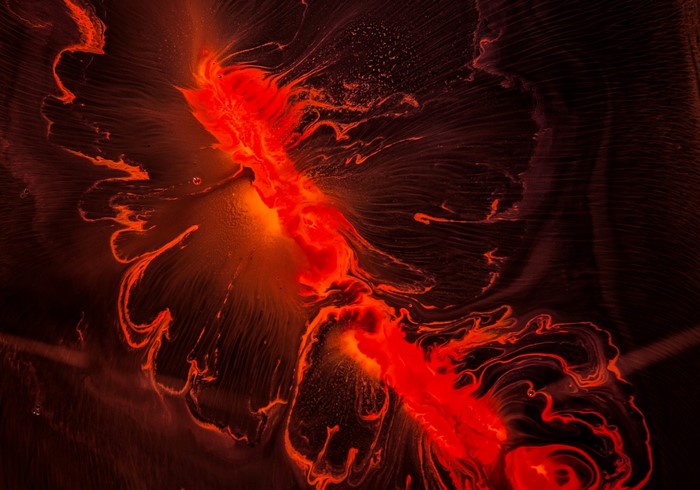 Abstract red and orange fluid art with dark background