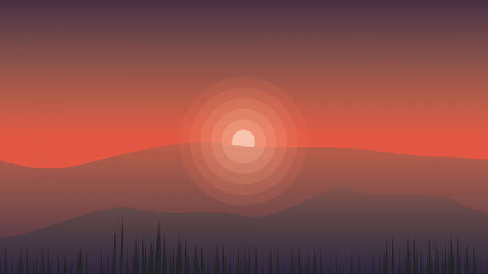 Sunset over rolling hills with grass in foreground