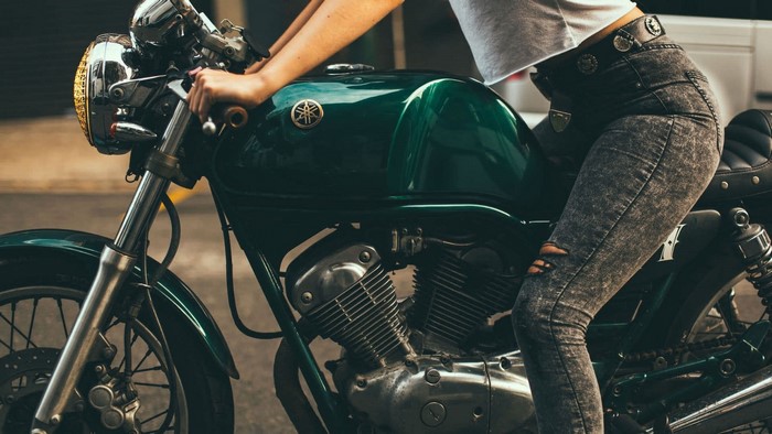 Woman on a green Yamaha motorcycle