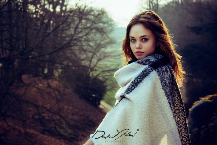 Woman in a poncho posing outdoors