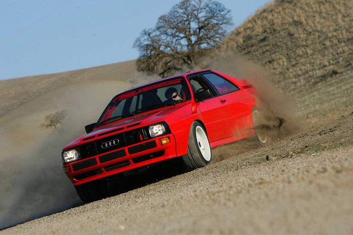 Red Audi Ur Quattro drifting on a dirt road