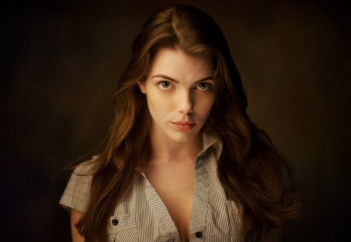Woman with long brown hair in a striped shirt