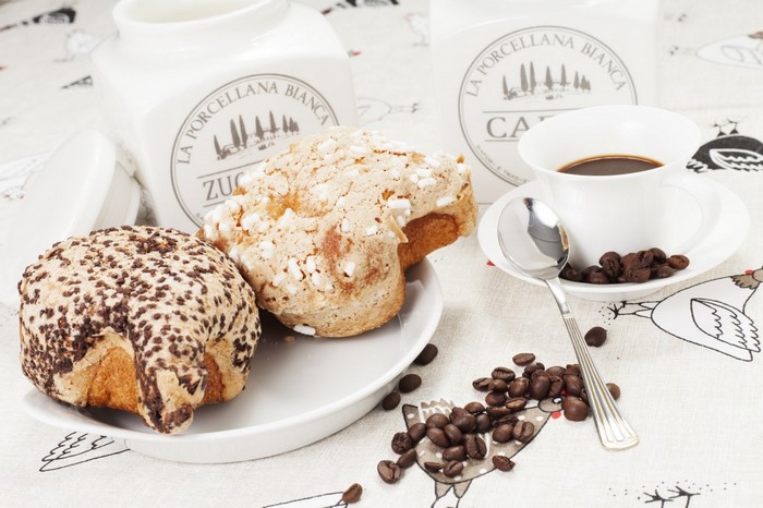 Coffee cup with pastries and coffee beans