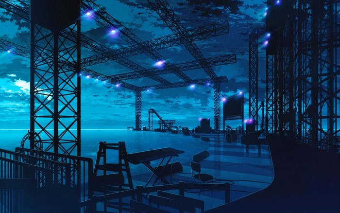Stage lighting rig over water at night
