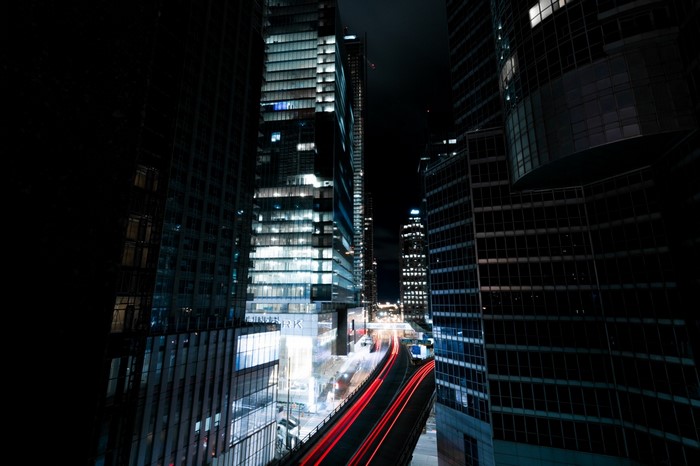 Cityscape at night with light trails from traffic
