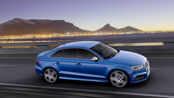 Blue Audi S3 Sedan driving on a road at dusk