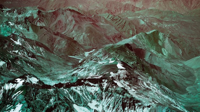 Aerial view of snow-capped mountains and valleys