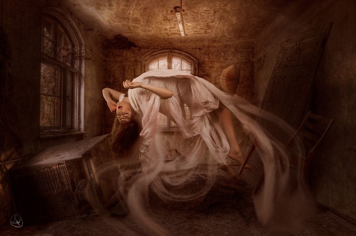 Woman floating in abandoned room by Nikolas Verano