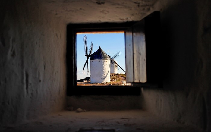 View of windmills through a window