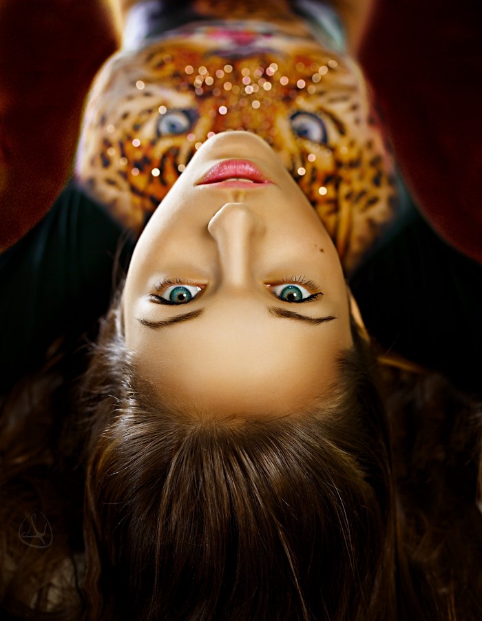 Woman with leopard face paint and bokeh lights