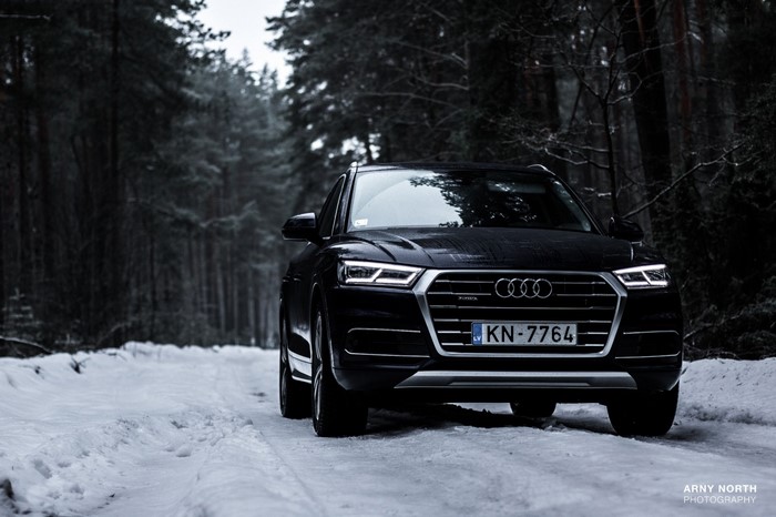 Black Audi Q5 on a Snowy Forest Road