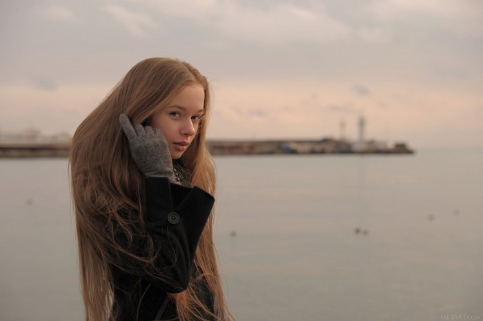 Girl with long hair by the sea