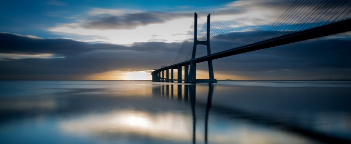 Vasco da Gama Bridge at sunrise over the sea