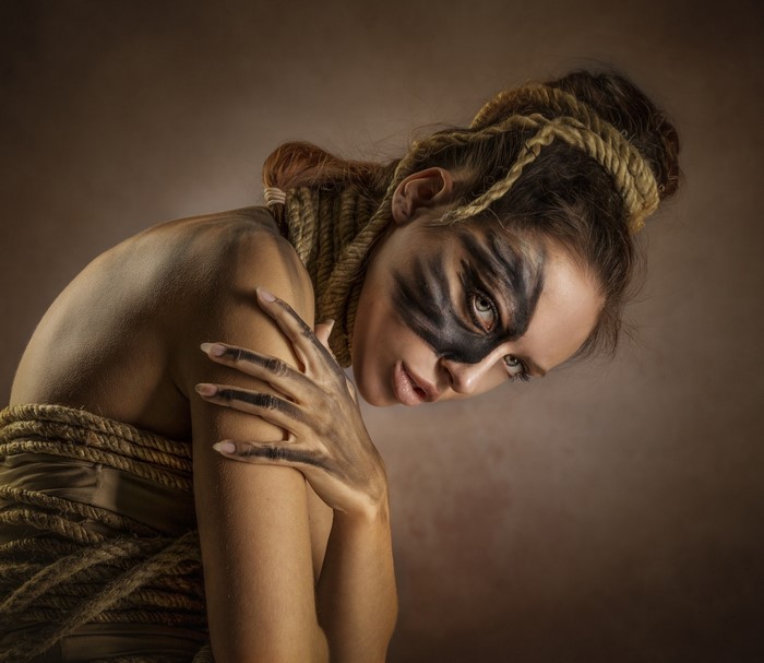 Woman with tribal makeup and rope
