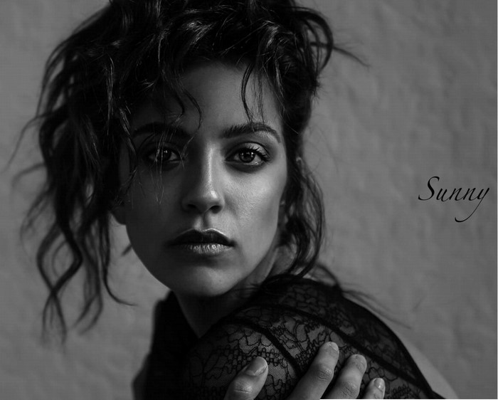 Monochrome portrait of a woman with dark curly hair