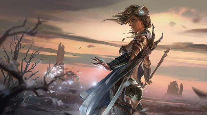 Fantasy warrior woman with staff in desolate landscape