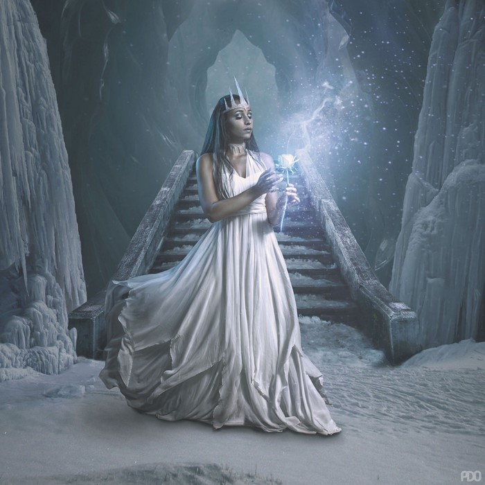 Fantasy woman in white dress holding a glowing rose