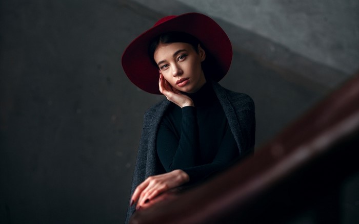 Woman in red hat and grey coat