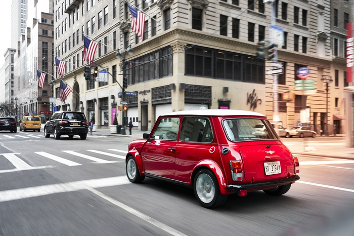 Red Mini Electric Concept Car Driving in City