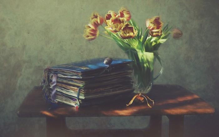 Still life painting of tulips and a book