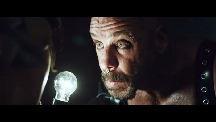 Till Lindemann with a light bulb