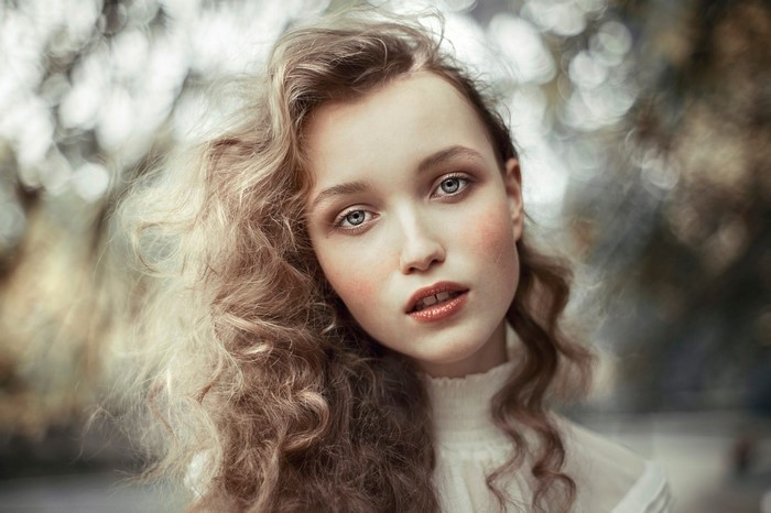 Portrait of Woman with Curly Hair and Blue Eyes