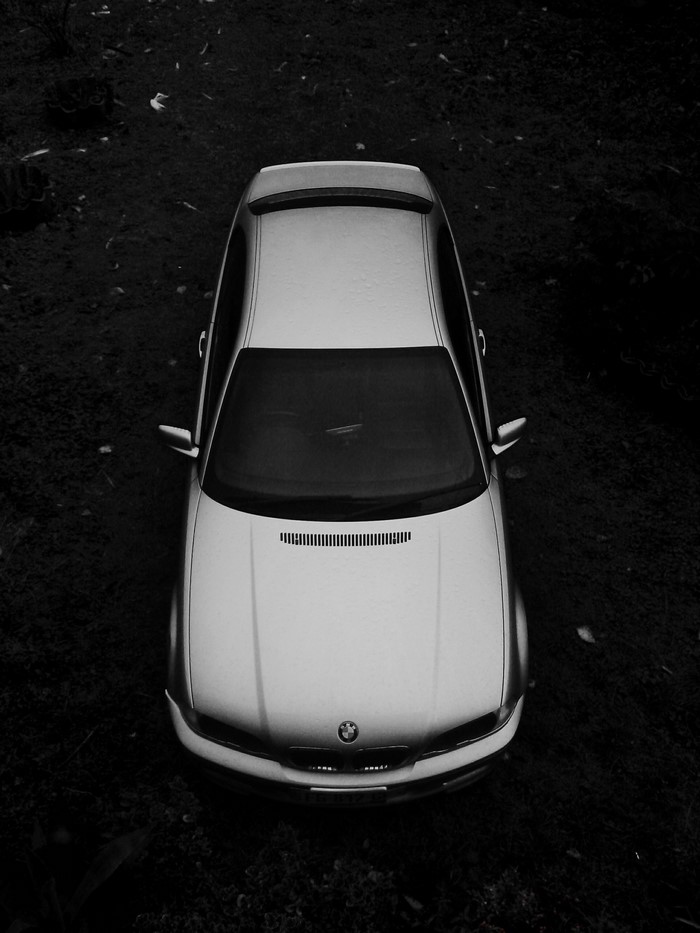 Monochrome overhead view of a silver BMW car