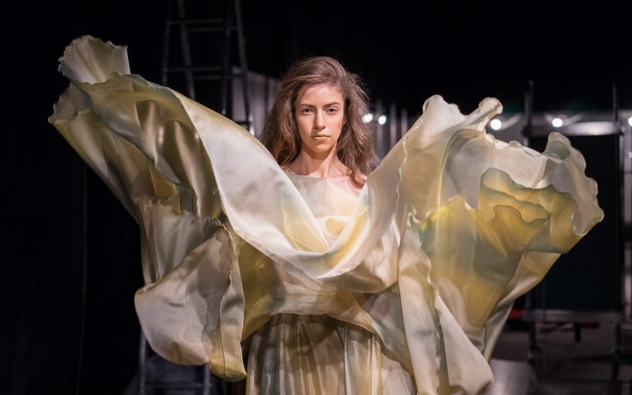 Woman in flowing dress on stage