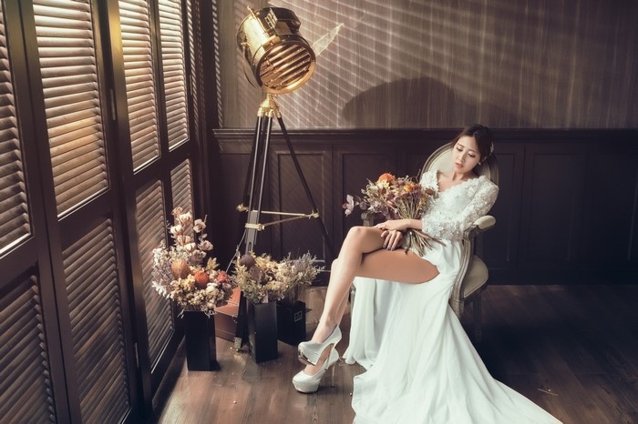 Bride in Elegant White Wedding Dress with Bouquet