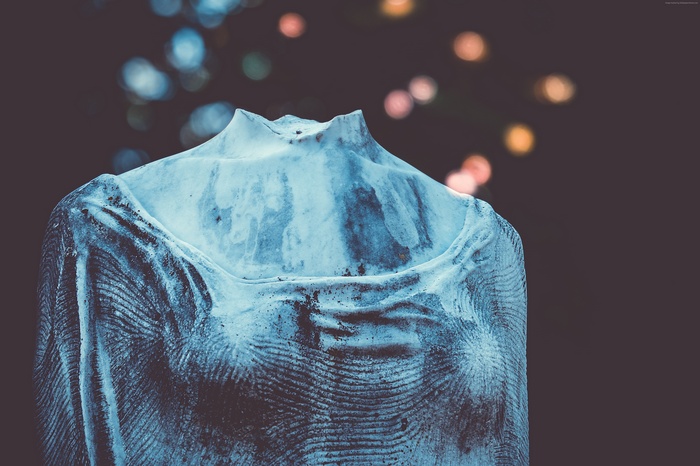 Statue torso with bokeh lights