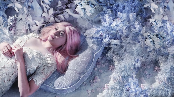 Elizabeth Olsen with pink hair in a floral setting