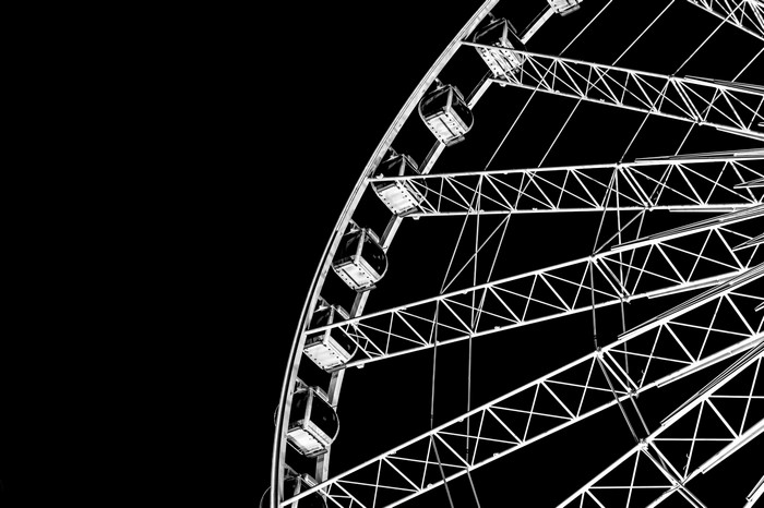 Minimalist black and white Ferris wheel close-up