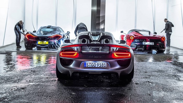 Three supercars being washed by men