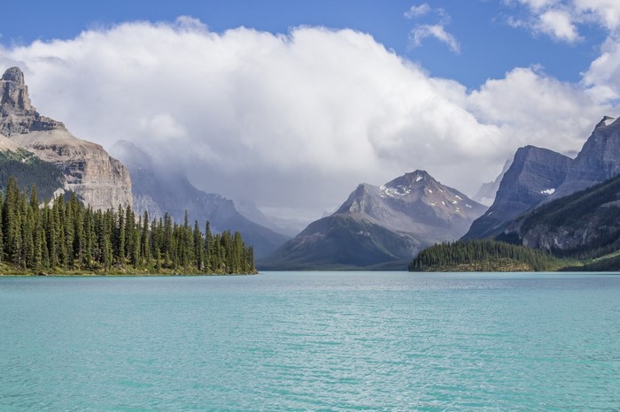 Turquoise lake with mountains and clouds